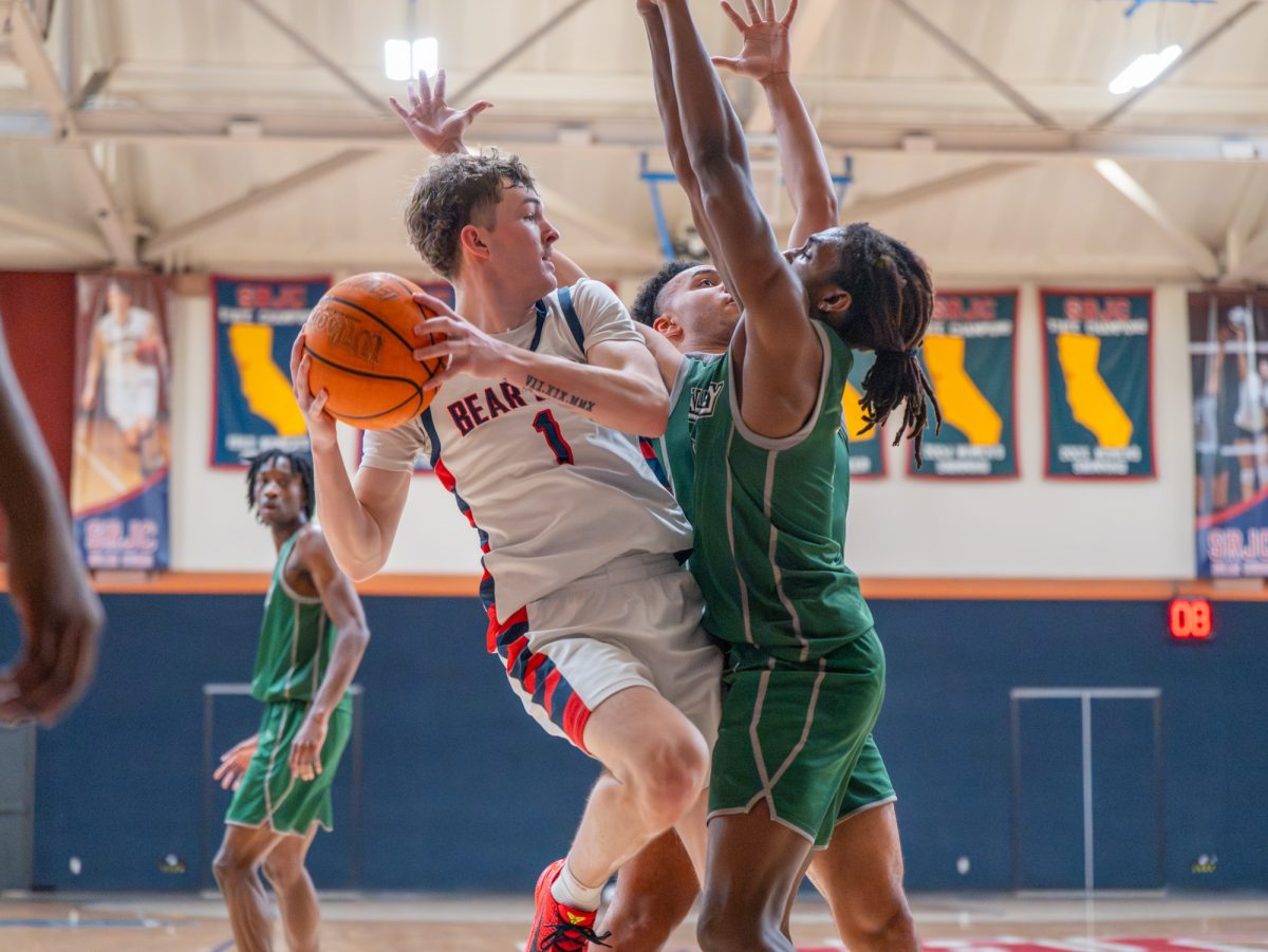 Freshman guard Tatum Kurpinsky braces against Diablo Valley defense as he looks for an open pass during the game on Friday, Jan. 30 at home.