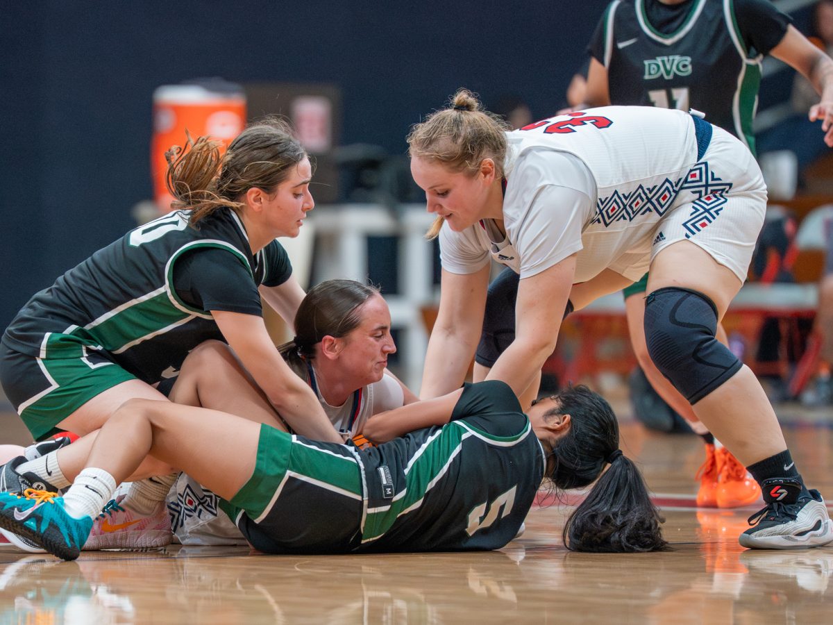 Bear Cub freshmen Madyson Carson, center, and Amanda Hart, right, fight to keep possession for the jump ball call against Diablo Valley College on Friday, Jan. 30 at home.