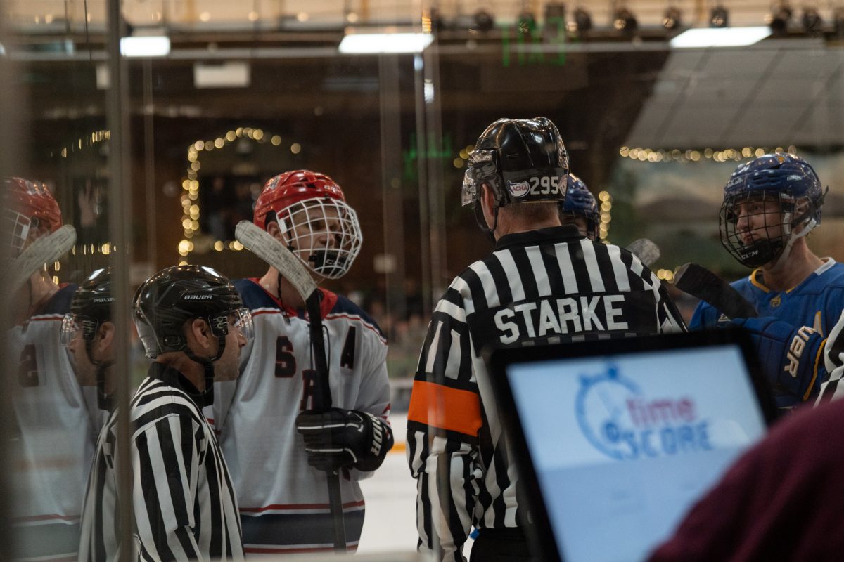 Polar Bear Adam Berry negotiates with referees after two simultaneous fights on the ice against San Jose at Snoopy’s Home Ice Friday, Feb. 20, 2026.