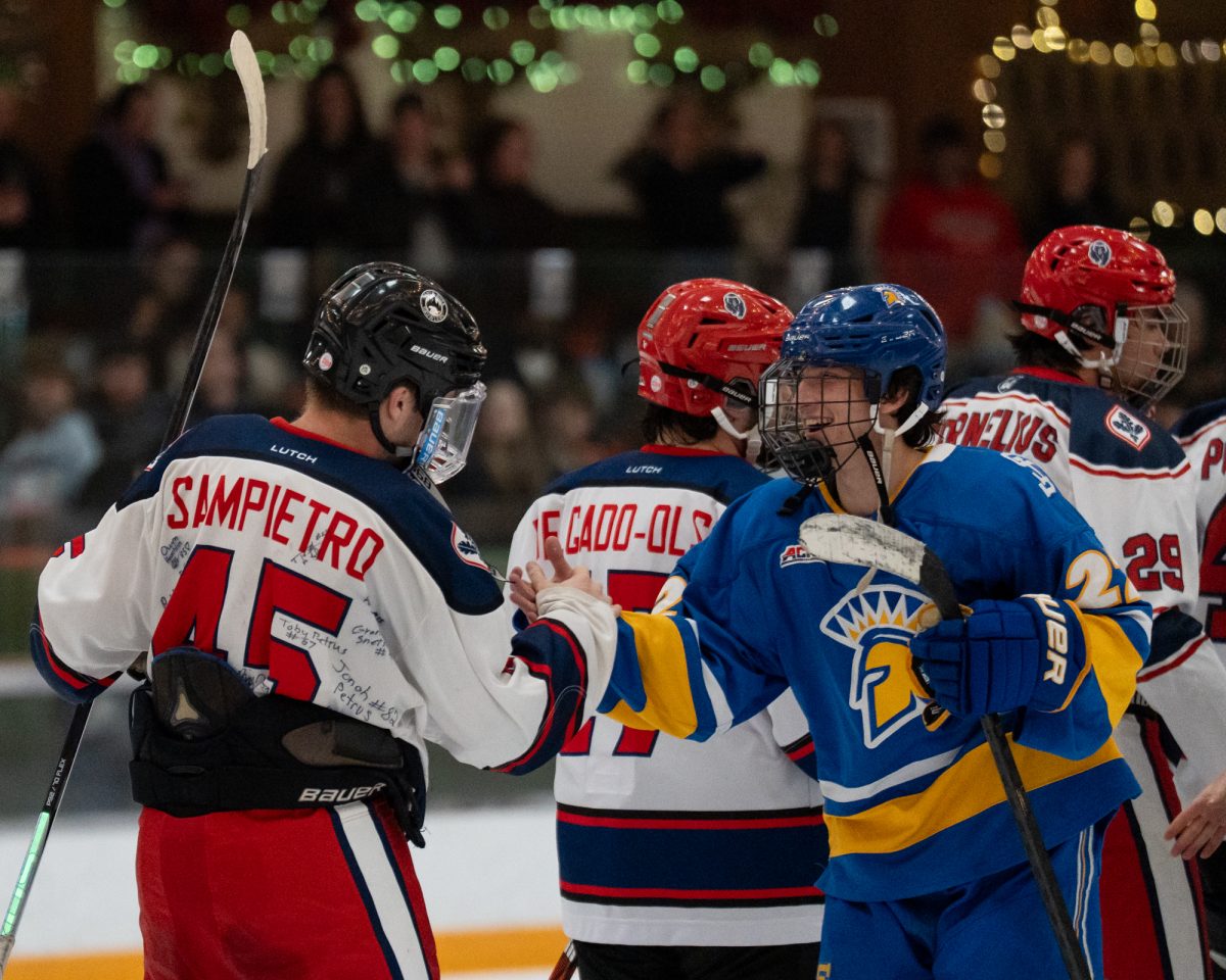 Polar Bear Joshua Sampietro ends the game with a handshake from former Santa Rosa player, now Spartan Connor Colbert at Snoopy’s Home Ice Friday, Feb. 20, 2026.