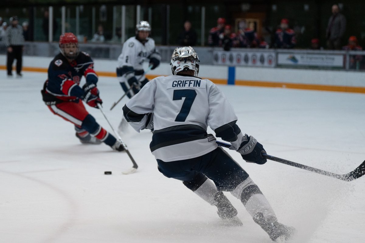 Reno forward Franklin Griffin shreds the ice before attempting a takeaway on Santa Rosa defenseman and right winger Owen Hamblin Friday, Feb. 6 at Snoopy's Home Ice.