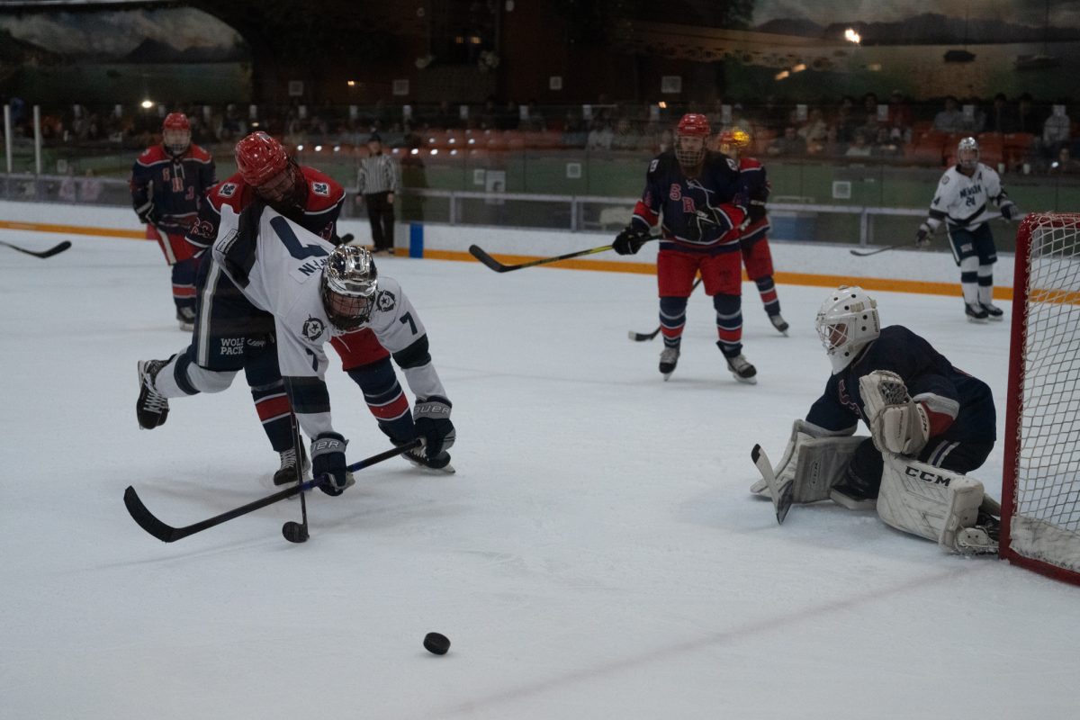 Polar Bear defenseman and winger Matt Gunter folds Wolfpack forward Franklin Griffin after an attempted shot Friday, Feb. 6 at Snoopy's Home Ice.
