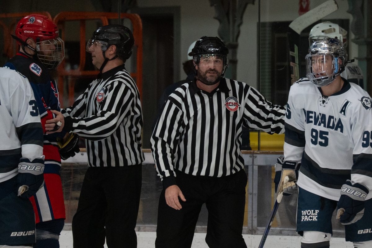 Referees separate Santa Rosa defenseman and winger Jon Christenson and Reno forward Christopher Lai after a scuffle Friday, Feb. 6 at Snoopy's Home Ice.