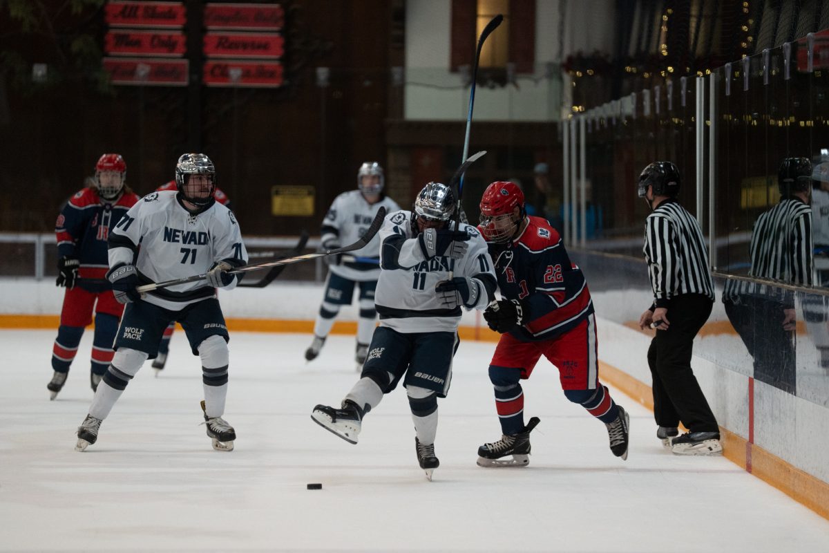 Santa Rosa winger Antonio Hernandez attempts to regain possession of the puck from Reno forward Trenton Wagner after a turnover Friday, Feb. 6 at Snoopy's Home Ice.