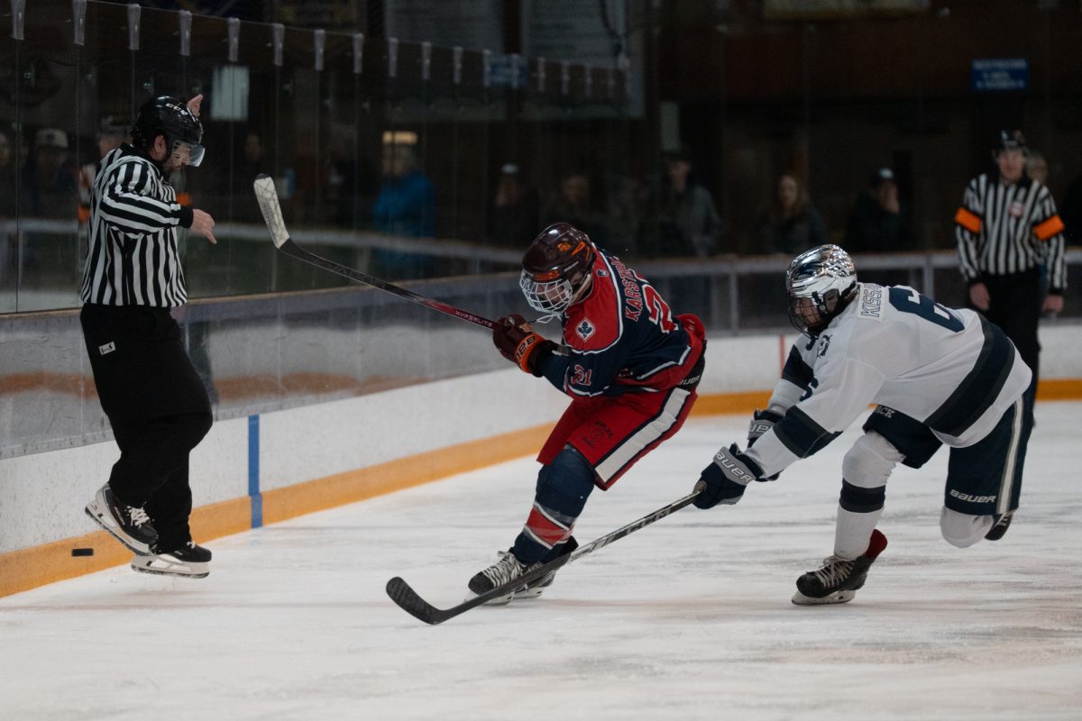 Polar Bear Will Karstrand races to beat Wolfpack defenseman Danny Kissane to the puck Friday, Feb. 6 at Snoopy's Home Ice.