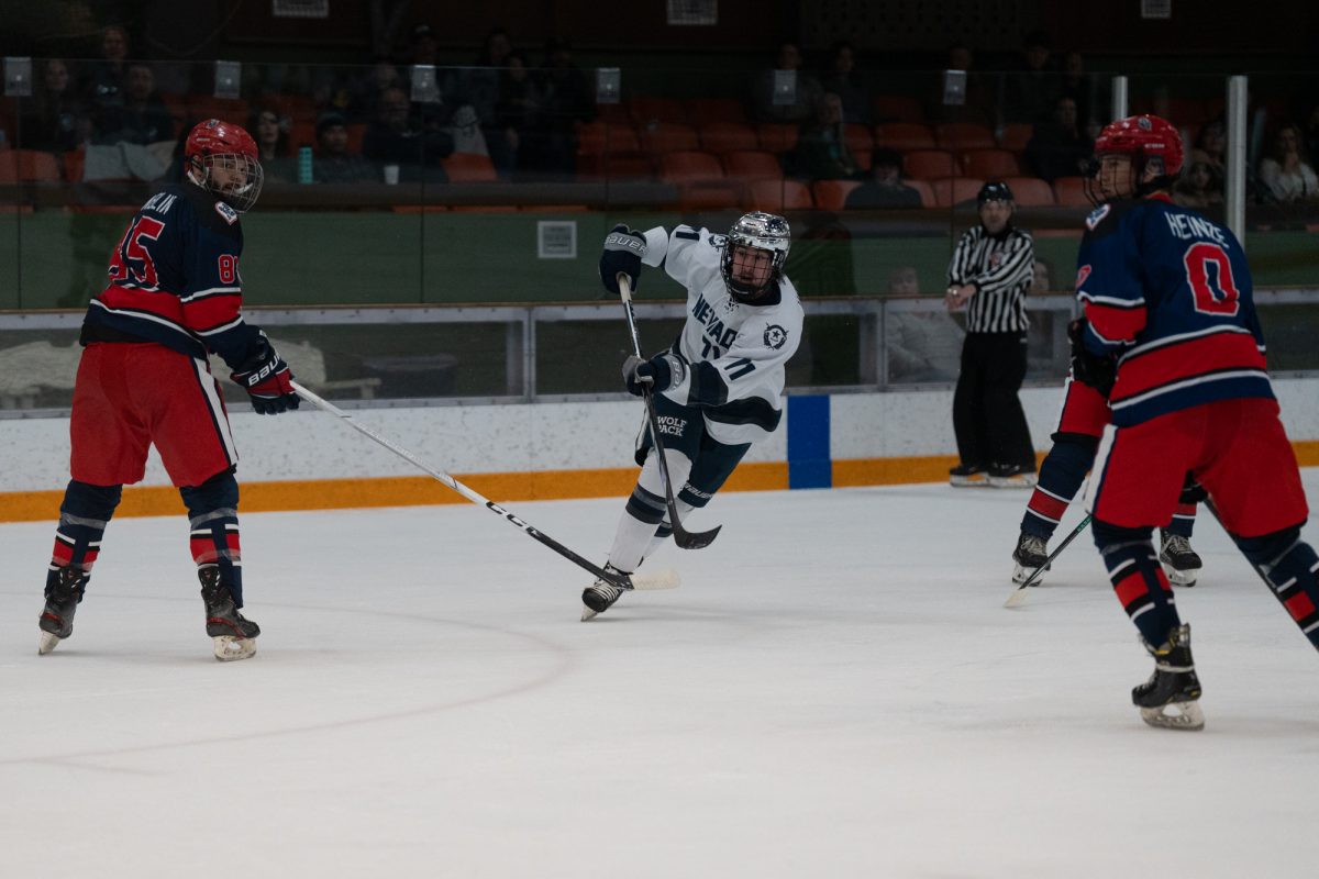 Wolfpack defenseman Alexey Ustinov opens up for a pass as Polar Bears defensemen Owen Hamblin and August Heinze close in Saturday, Feb. 7 at Snoopy's Home Ice.