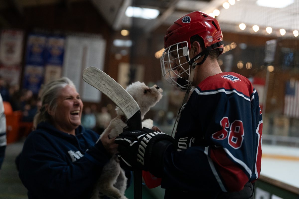 Wolfpack mom, Melissa Lai, introduces Polar Bear center Adam Berry to the cutest member of the Wolfpack, Barley, breaking the tension between periods Saturday, Feb. 7 at Snoopy's Home Ice.