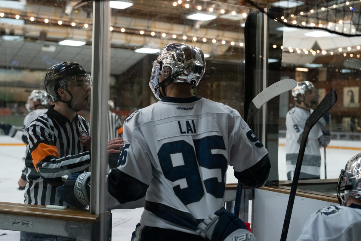 Wolfpack forward Christopher Lai opens the door to the penalty box to argue with a referee as teammate Franklin Griffin tries to pull him back Saturday, Feb. 7 at Snoopy's Home Ice.