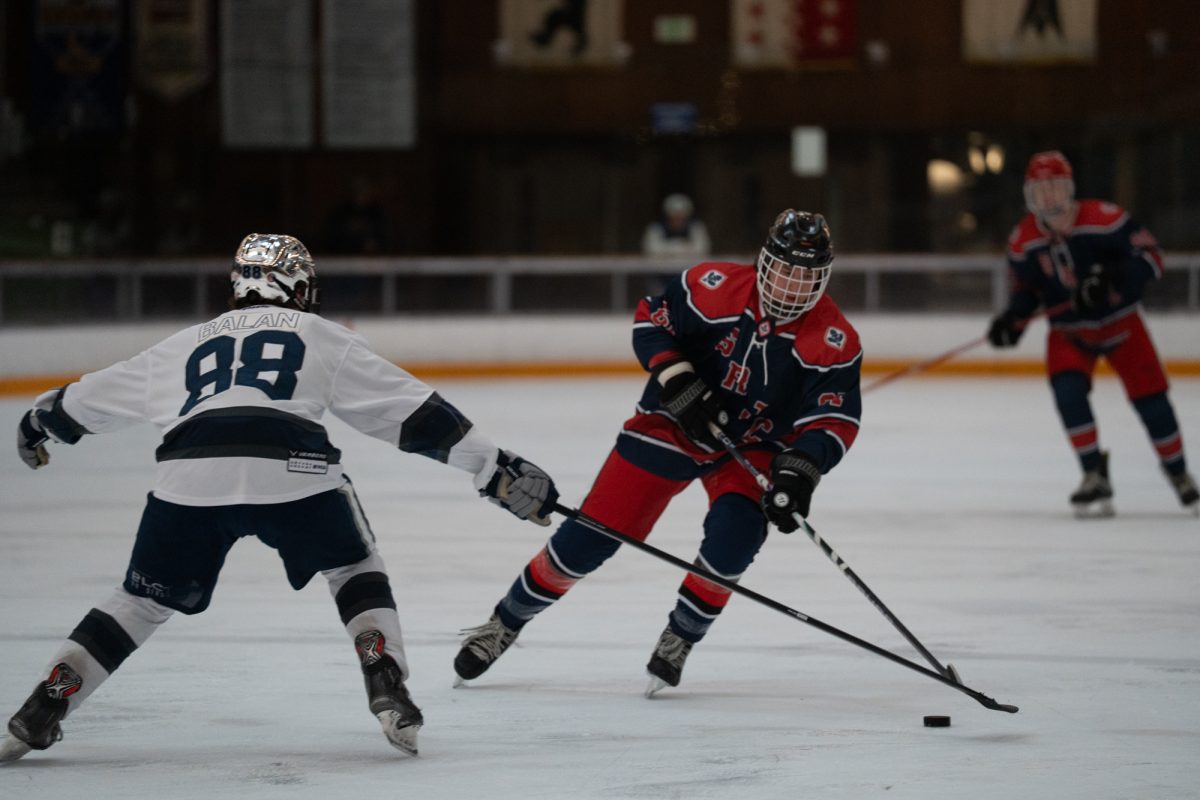 Wolfpack defenseman Jayden Balan attempts to steal the puck from Polar Bear possession Saturday, Feb. 7 at Snoopy's Home Ice.