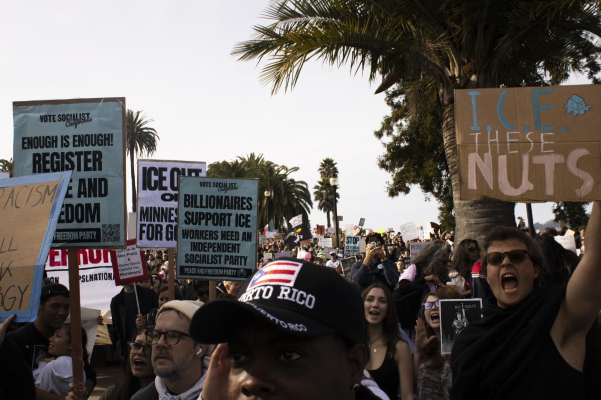 Protesters chant in unison while holding signs at Dolores Park during the ICE Out protest Friday, Jan. 30, 2026.
