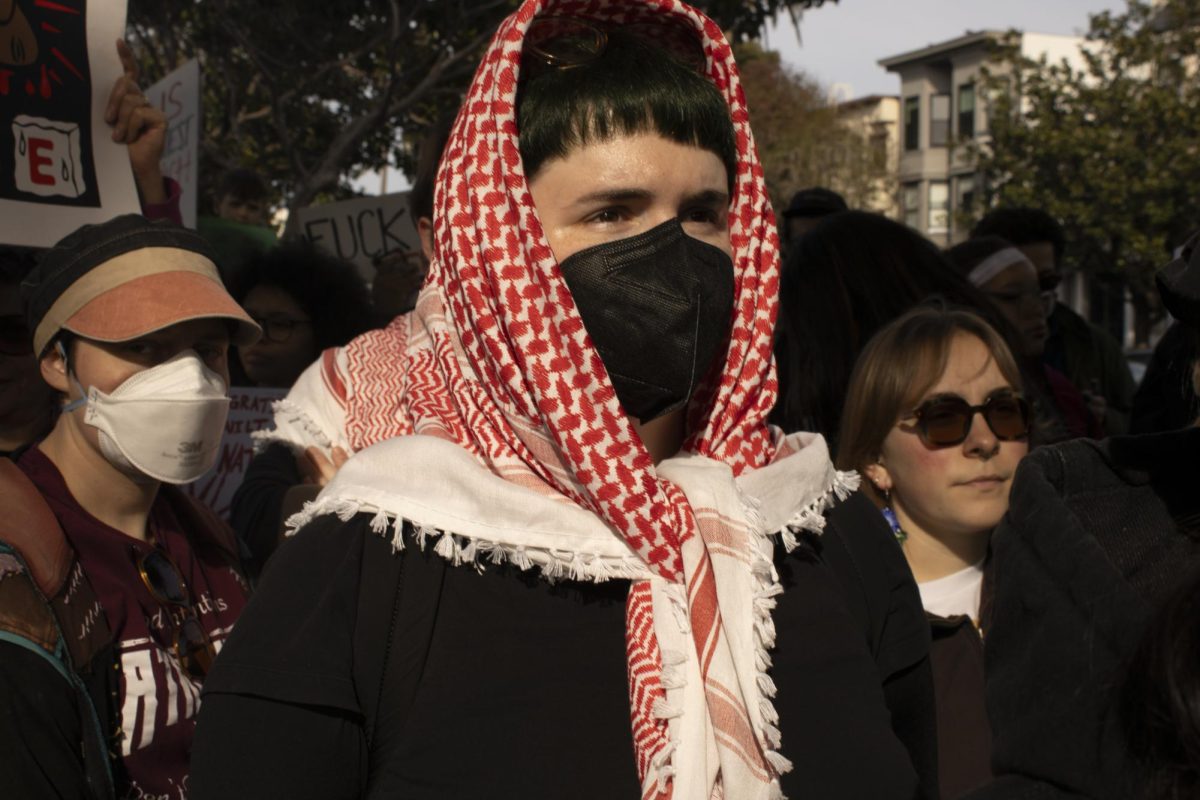 Masked protesters listen to speeches during the ICE Out protest at Dolores Park Friday, Jan. 30, 2026.