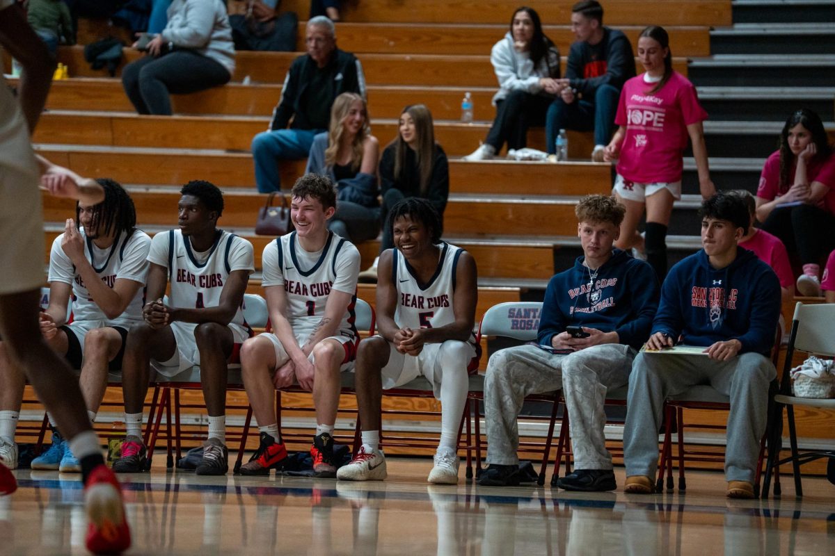 Bear Cubs forward Tayden Collins (left), forward Dave Baraka, guard Tatum Kurpinsky and guard Gavin Cook-Whisenton share a laugh on the sidelines during a match against Sierra Feb. 10 at Haehl Pavilion.