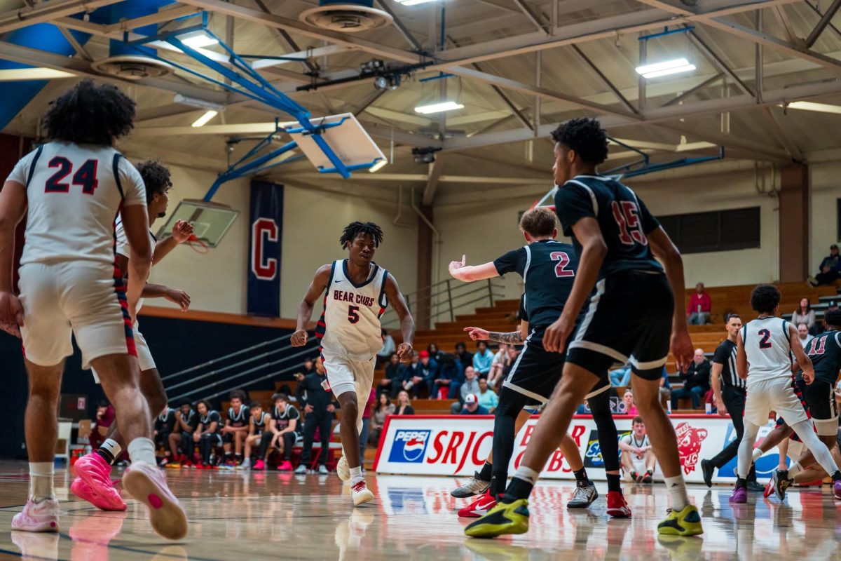 Bear Cubs sophomore guard Gavin Cook-Whisenton runs through the parted sea of his SRJC teammates and Sierra rivals Feb. 10 at Haehl Pavilion.