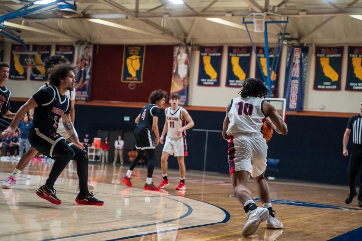 Bear Cubs sophomore guard Amari Gray moves to pass to sophomore forward Vincent Jackson during a match against Sierra Feb. 10 at Haehl Pavilion.