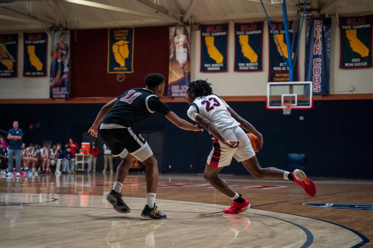Bear Cubs sophomore forward Travis Hightower weaves around Sierra sophomore Dontrell Johnson Feb. 10 at Haehl Pavilion.