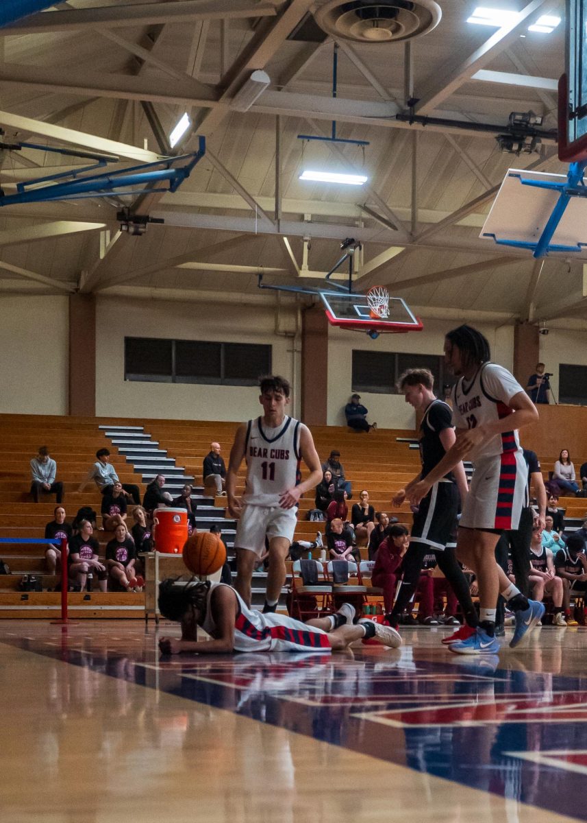 Bear Cubs Spencer Langowski (left) and Tayden Collins (right) watch as sophomore guard Amari Gray gets hit with a stray basketball during a match against Sierra Feb. 10 at Haehl Pavilion.