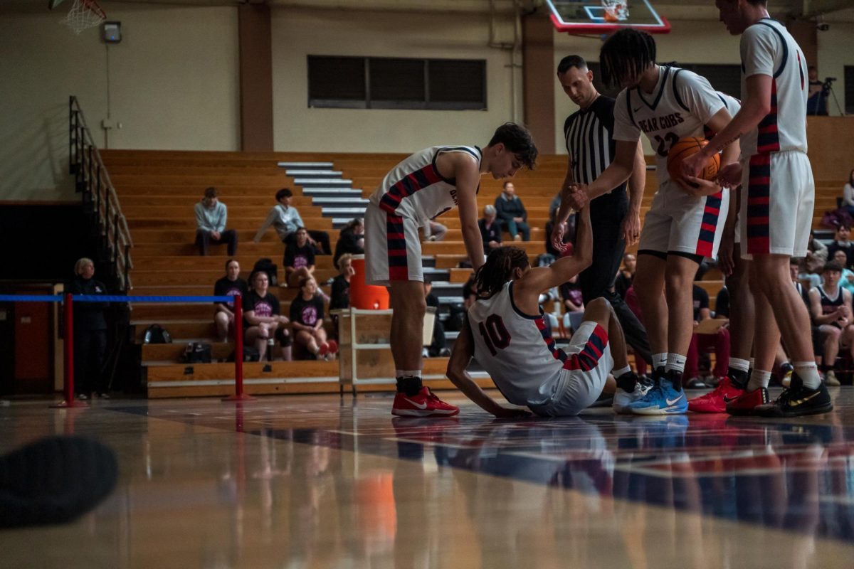 Bear Cubs Tayden Collins (right) and Spencer Langowski (left) help sophomore guard Amari Gray up after a fall during a match against Sierra Feb. 10 at Haehl Pavilion.