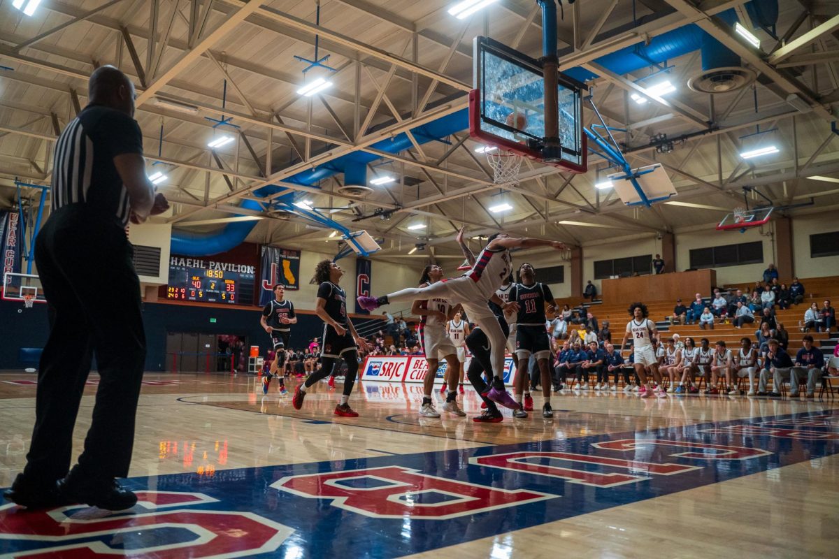 Bear Cubs freshman guard Gavin Early gives it his all blocking a shot from Sierra Feb. 10 at Haehl Pavilion.