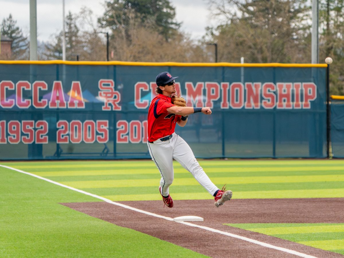 Sophomore third baseman Caze Dermmelaere launches the ball to first to get the batter out against College of Marin on Saturday, Feb. 14 at home.