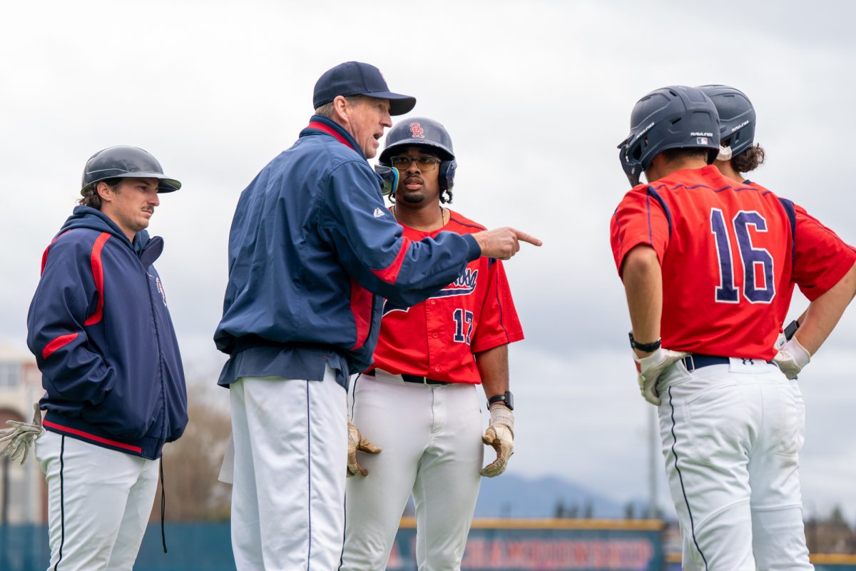 Bear Cubs head coach Damon Neidlinger, center, calls time out to speak with his team in the bottom of the eleventh against College of Marin on Saturday, Feb. 14 at home.