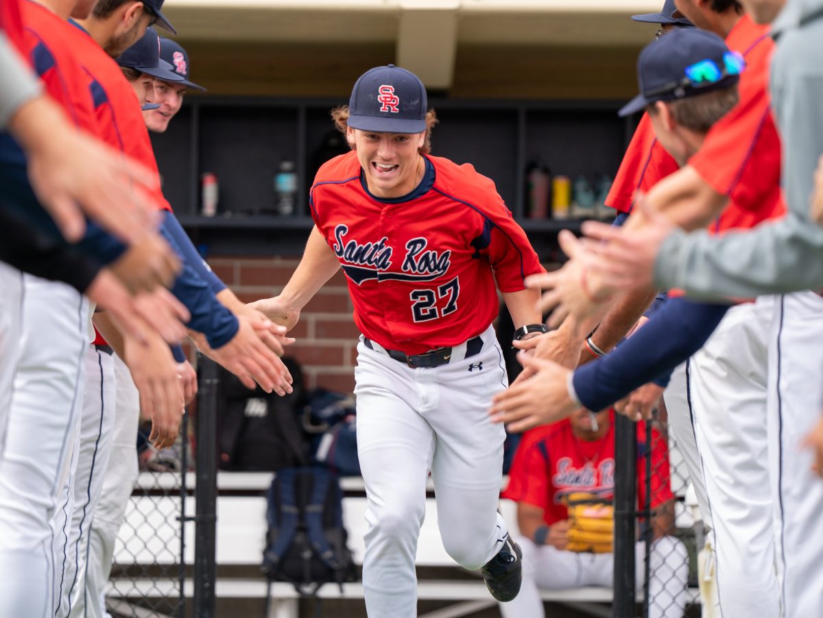 Right fielder Will Clayton runs out to the field ahead of the game against College of Marin on Saturday, Feb. 14 at home.