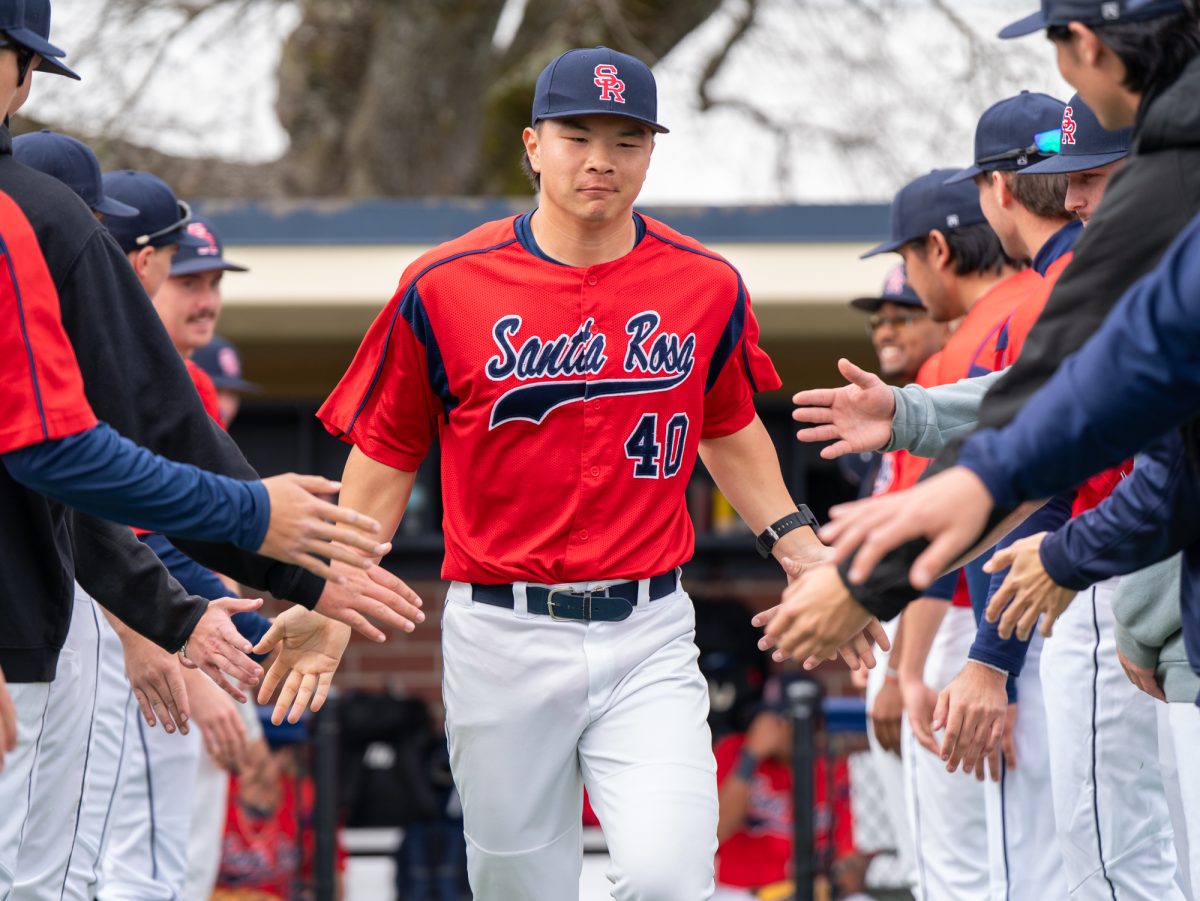 Designated hitter Aidan Sakai walks down the lineup as his name is announced ahead of the game against College of Marin on Saturday, Feb. 14 at home.