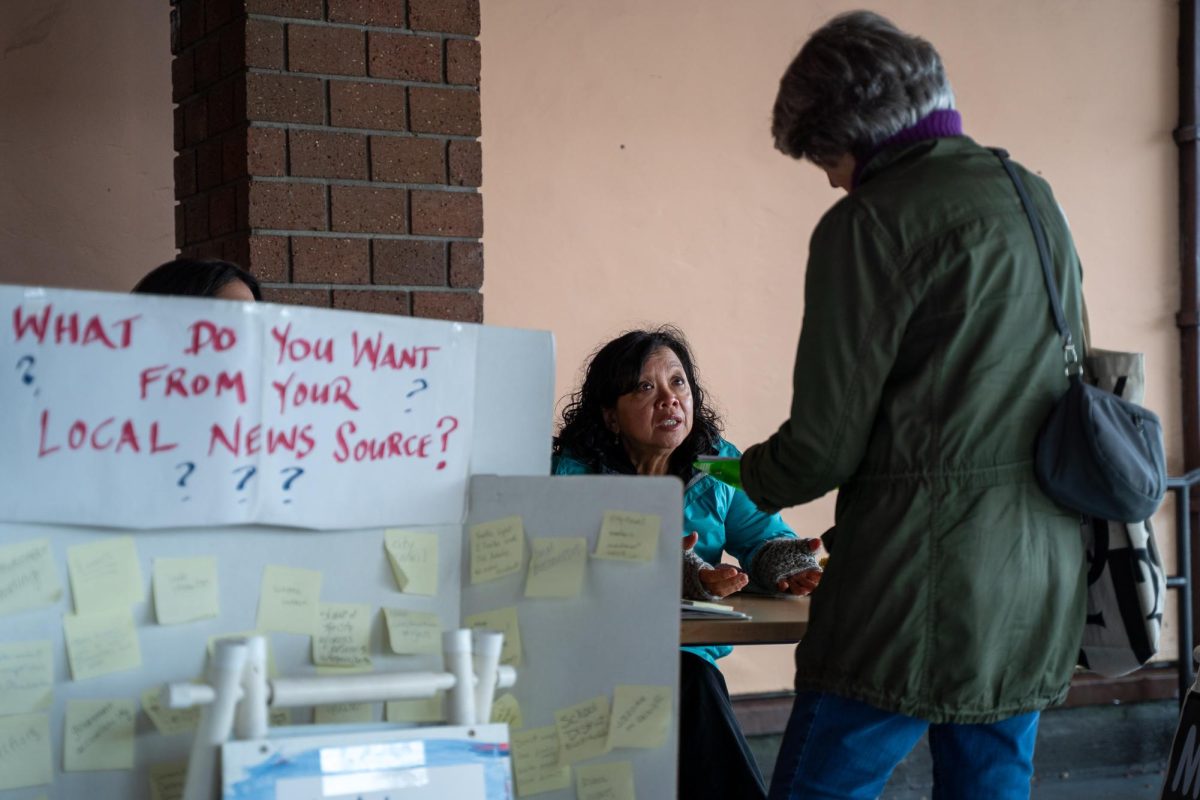 Crissy Pascual talks to a Petaluma resident about Petaluma Voice, the town's newest nonprofit news source, Feb. 11 outside the Petaluma Regional Library.