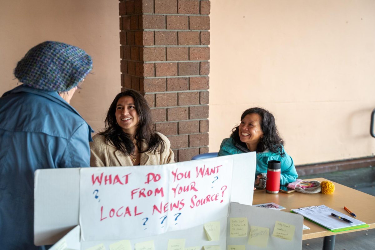Jennifer Sawhney (left) and Crissy Pascual (right) talk with Petaluma residents about what information they want included in the newspaper Feb. 11 outside the Petaluma Regional Library. 