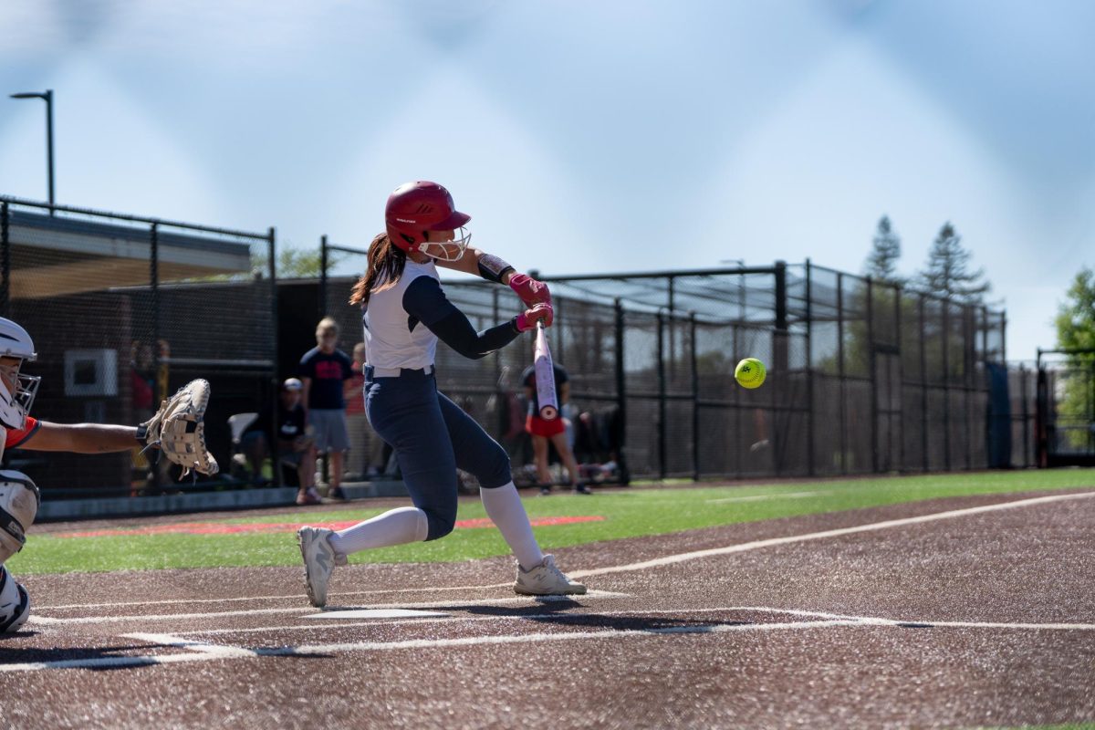 Santa Rosa shortstop Kylee Bauman swings the bat as the ball comes flying towards the plate during the game against Cosumnes River College at home on Tuesday, March 24, 2026.
