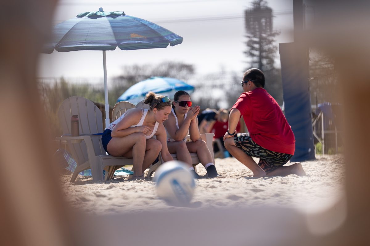 Bear Cubs Issa McIninch Rosko(left) and Lily Seidler(center) cool off and strategize between sets against Butte College with assistant coach Tommy Wong-Araki(right) at Spring Hills Church Feb. 23, 2026.