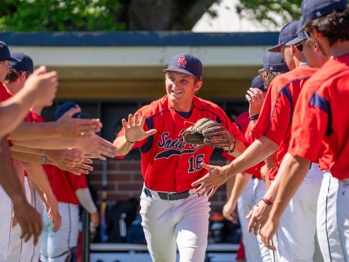 Second baseman Trevor Schlafer runs through a tunnel of high fives during lineup announcements against American River College at home on Thursday, March 19, 2026.