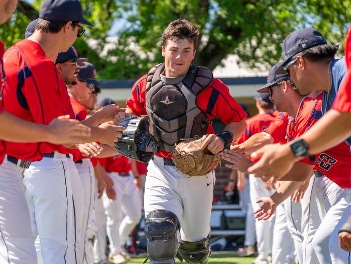 Catcher RJ Johnson runs towards the pitching mound for the national anthem before the matchup against American River College at home on Thursday, March 19, 2026.