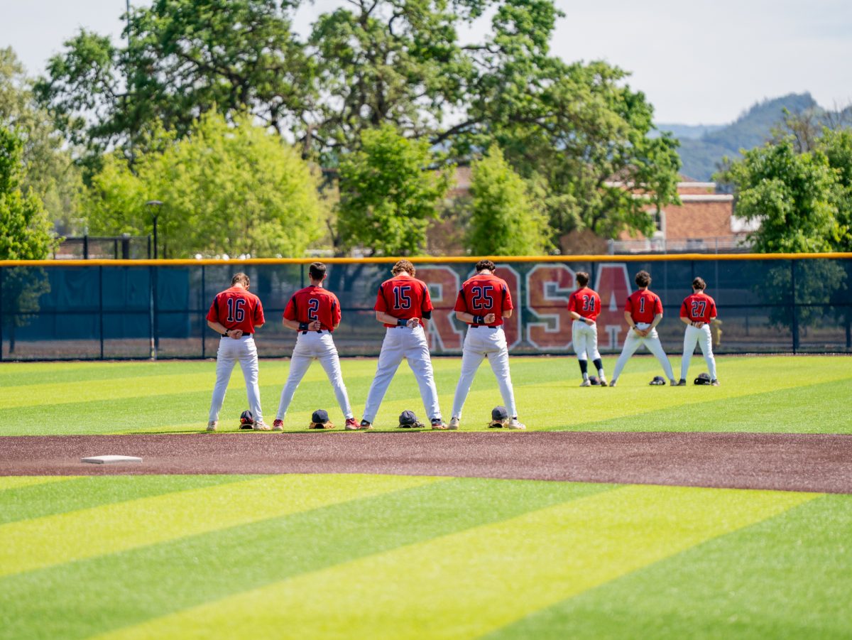 Starting players for Santa Rosa's infield and outfield face towards the flag during the national anthem prior of the game against Diablo Valley College at home on Friday, March 27, 2026.