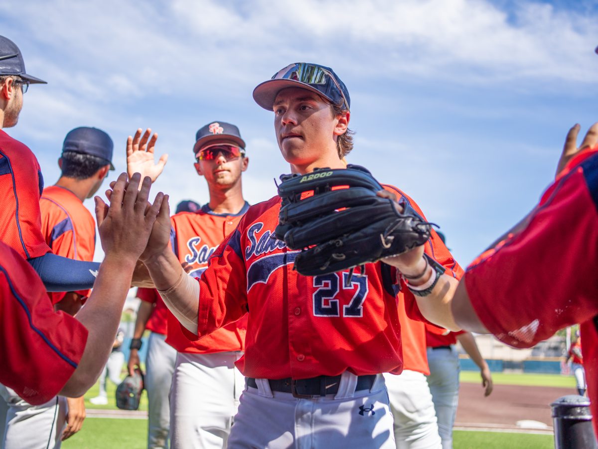 Right fielder Miles Clayton walks back into the dugout high-fiving teammates during the game against Diablo Valley College at home on Friday, March 27, 2026.