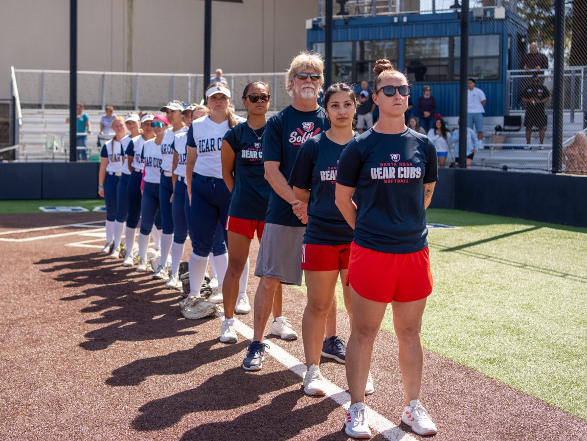 Head coach Madison Green stands in front of the coaching staff and team during the national anthem prior to the team's first game against Folsom Lake College at home on Saturday, March 28, 2026.