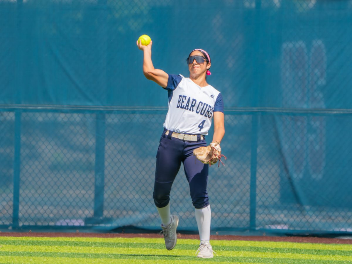 Sophomore right fielder Mira Olvera launches the ball towards the infield to get a stop in the first game against Folsom Lake College at home on Saturday, March 28, 2026.