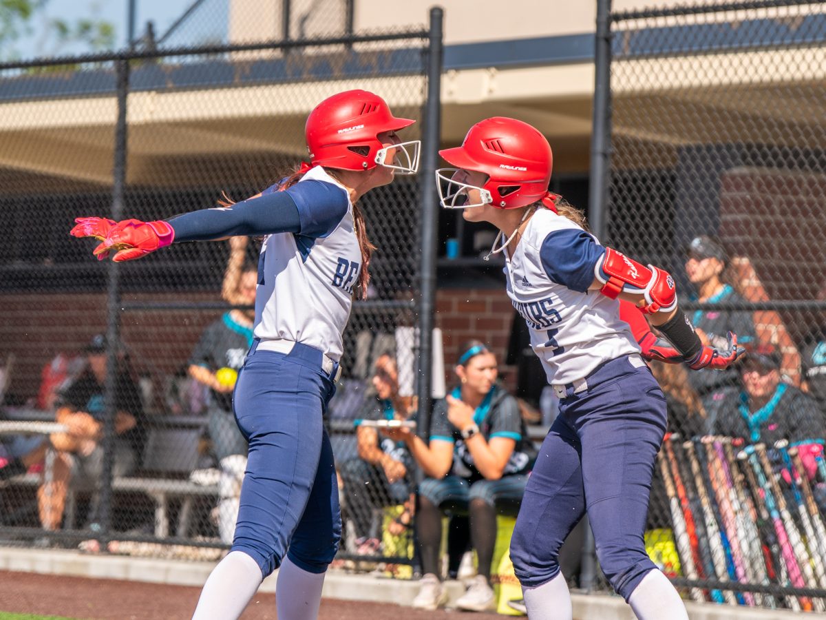 Center fielder Kylee Bauman, left, celebrates with shortstop Kaihla Jarvinen after Bauman scores in the bottom of the third of the second game against Folsom Lake College at home on Saturday, March 28, 2026.