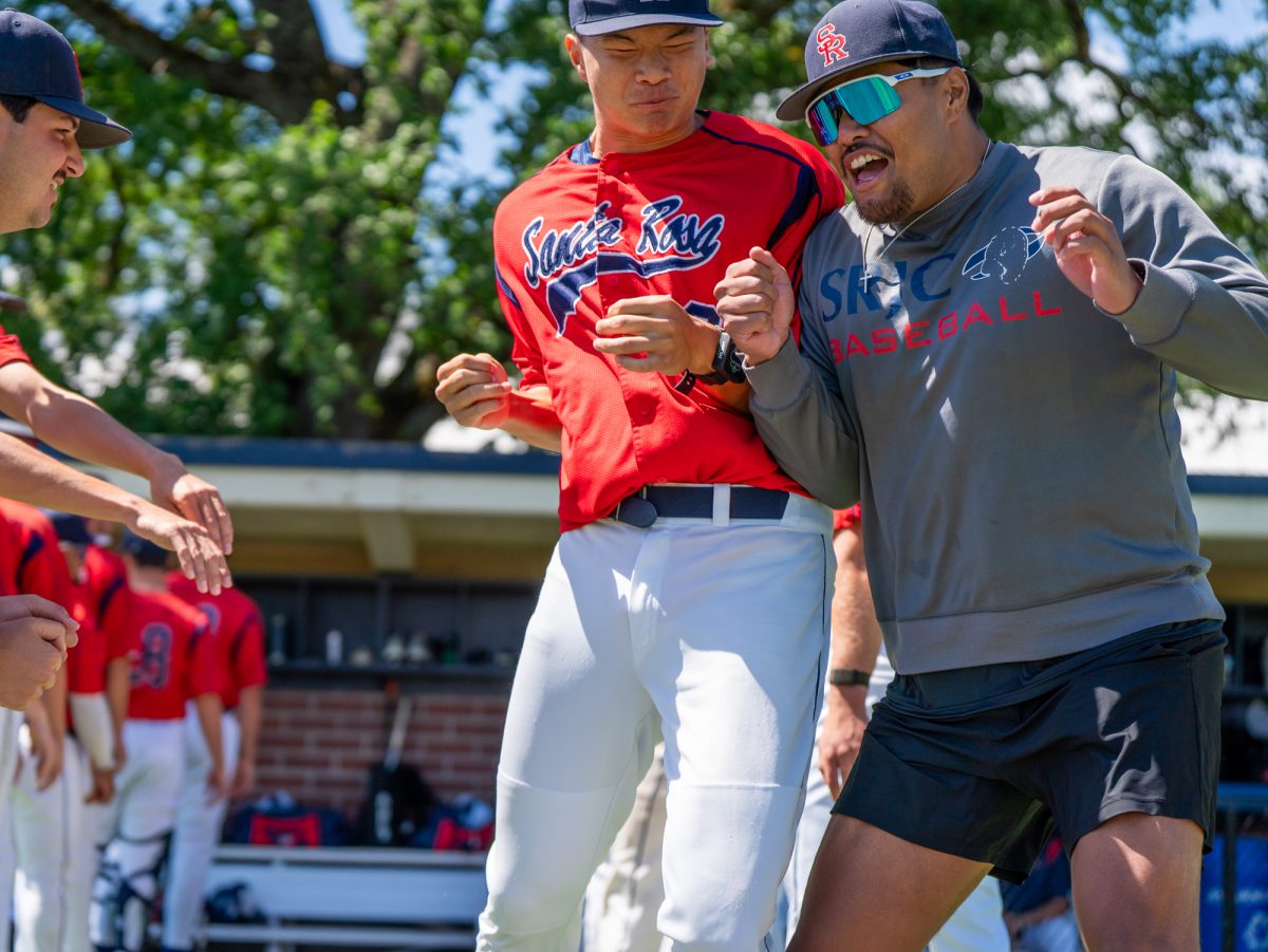 From left to right, designated hitter Aidan Sakai jumps up to bump shoulders with sophomore Vero Poueu during lineup announcements against Folsom Lake College at home on Tuesday, April 14, 2026.