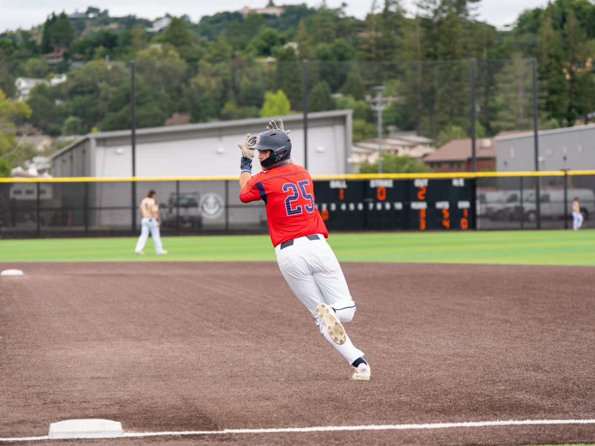 Sophomore J.T. Summers looks back towards the dugout and raises his hands in the air as he makes his way around the bases for his second three-run home run of the day against College of Marin on Sunday, May 3, 2026.
