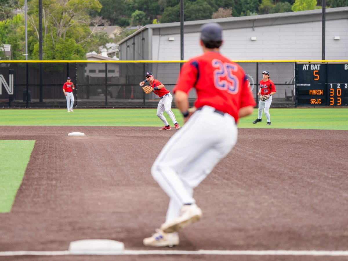 Sophomore shortstop Caze Derammelaere, back center, winds back to send the ball to first base for the out against College of Marin on Sunday, May 3, 2026.