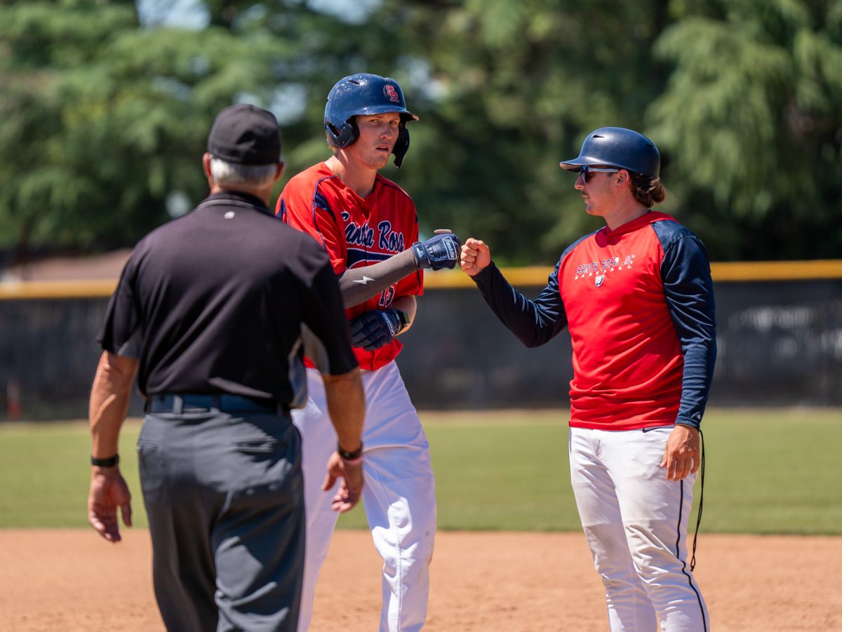 Brett Neidlinger fist bumps first base coach Connor Charpiot after singling to center field in the bottom of the fourth gainst Modesto Junior College in Modesto on Friday, May 8, 2026.