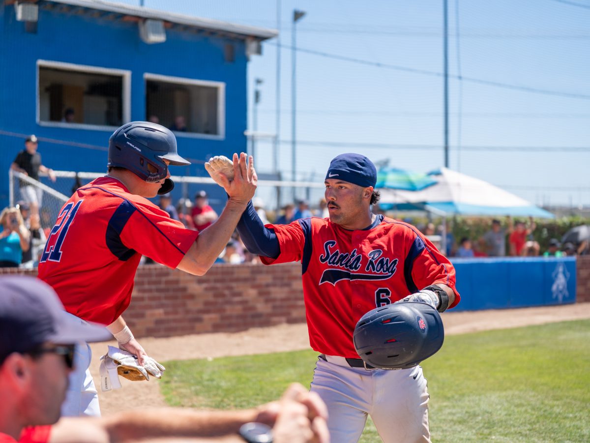 Justice Brinson, right, greets Nic Sebastiani after scoring in the bottom of the fifth against Modesto Junior College in Modesto on Friday, May 8, 2026.
