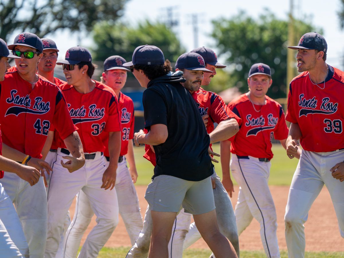 Closing pitcher Kessler Koch, center, is surrounded by teammates after striking his final batter out swinging in the bottom of the ninth against Modesto Junior College in Modesto on Saturday, May 9, 2026.