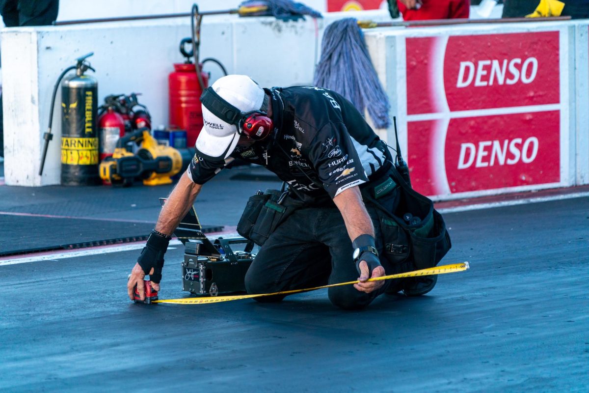 A member of Funny Car driver Alexis Dejoria's team checks track conditions before the second round of qualifying at the DENSO NHRA Sonoma Nationals on Friday, July 17, 2026 in Sonoma.