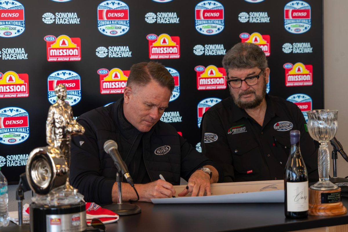 NHRA President Glen Cromwell, left, signs a declaration stating that Autódromo de Monterrey is officially an NHRA member track alongside its CEO Gilberto Jimenez, right, at the John Cardinal Media Center at Sonoma Raceway on Saturday, July 18, 2026 in Sonoma
