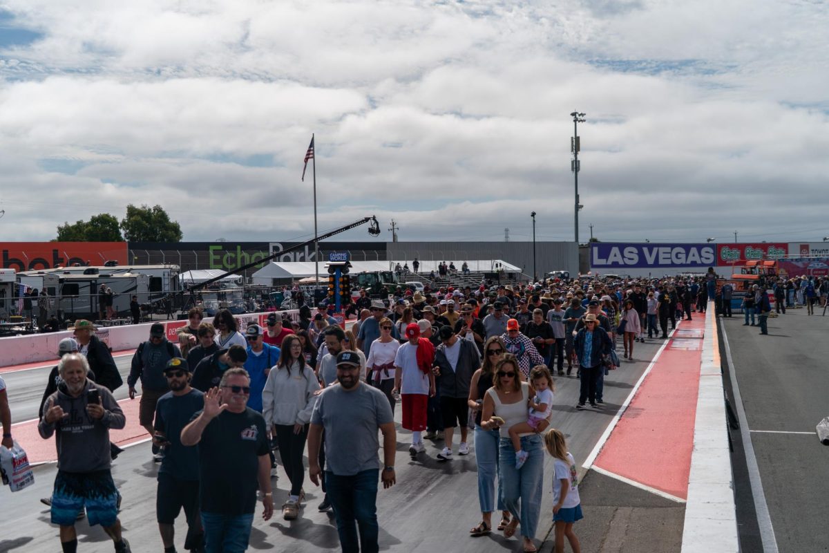 Fans walk the drag strip before the finals at the DENSO NHRA Sonoma Nationals on Sunday, July 19, 2026 in Sonoma.
