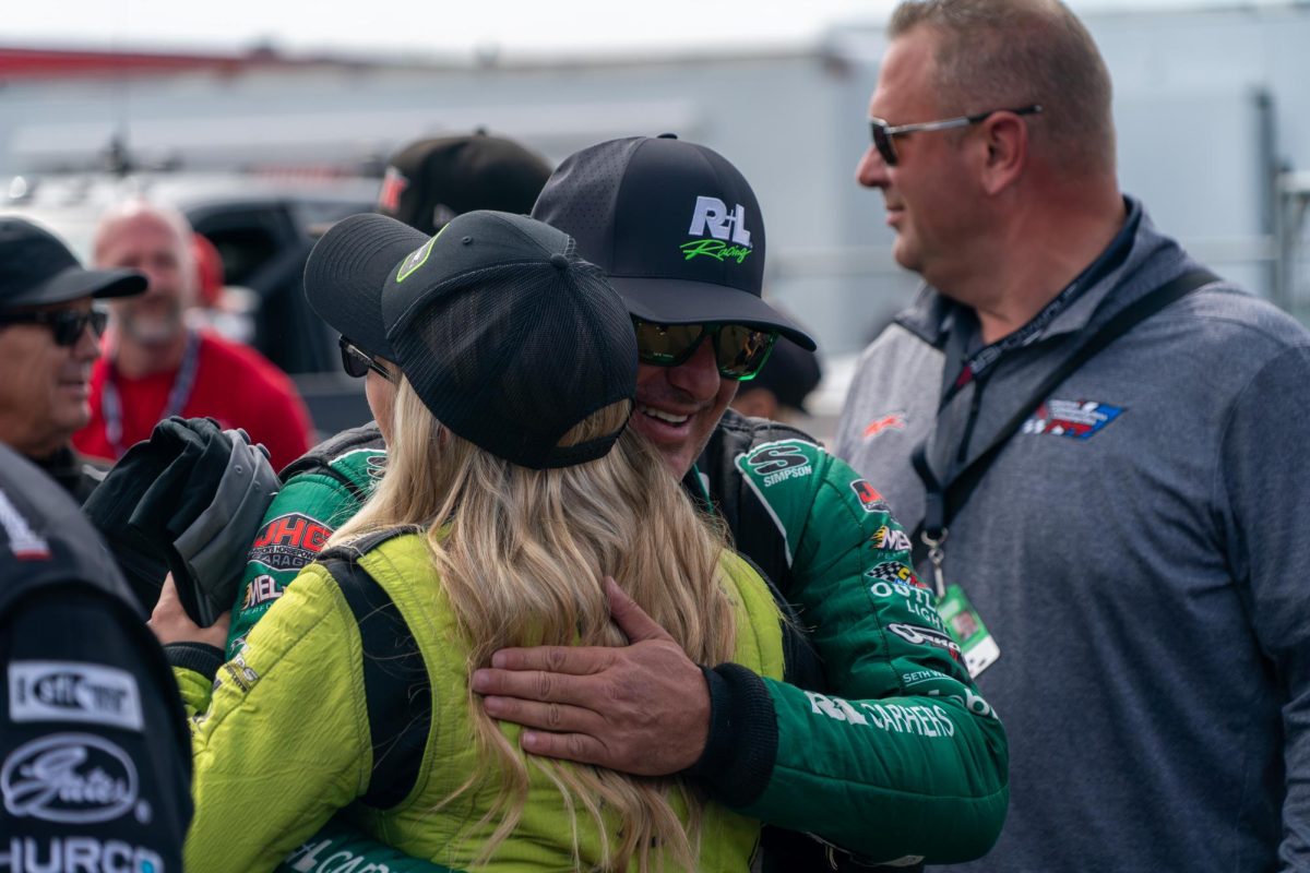 Top Fuel driver Tony "Smoke" Stewart hugs fellow driver Maddi Gordon during pre-race ceremonies at the DENSO NHRA Sonoma Nationals on Sunday, July 19, 2026 in Sonoma.