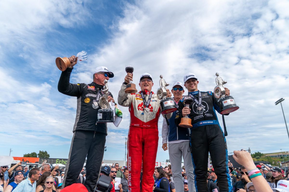 (Left to right) Pro Stock driver Greg Stanfield, Top Fuel driver Doug Kalitta, Sonoma Raceway VP Brian Flynn and Funny Car driver Jordan Vandergriff stand on the victory platform at the DENSO NHRA Sonoma Nationals on Sunday, July 19, 2026 in Sonoma.