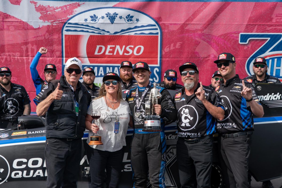 Funny Car driver Jordan Vandergriff, middle, stands with his team and race owner, John Force, front left, after winning at the DENSO NHRA Sonoma Nationals on Sunday, July 19, 2026 in Sonoma.